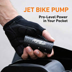 RoosCamp Air Master X Jet Bike Pump held in a cyclist’s hand, showing its compact carbon fibre body and pocket-sized design