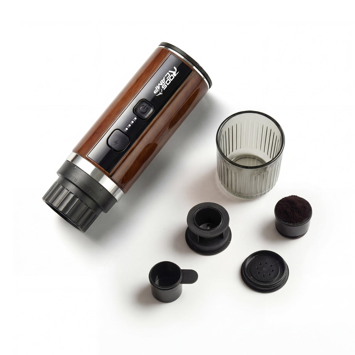 RoosCamp Pocket Esso brewing espresso – rich crema pouring into ribbed glass cup from portable self-heating coffee machine
