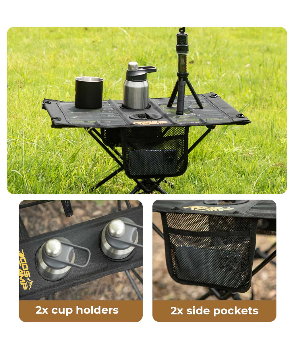 RoosCamp Portable Camping Table outdoors on grass with mug and flask on surface, close-up details showing 2x cup holders and 2x side mesh pockets