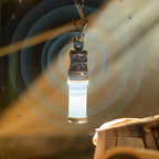 RoosCamp RoosRepel mosquito repellent camping lantern hanging from carabiner hook and glowing in the dark, surrounded by mosquitoes being repelled